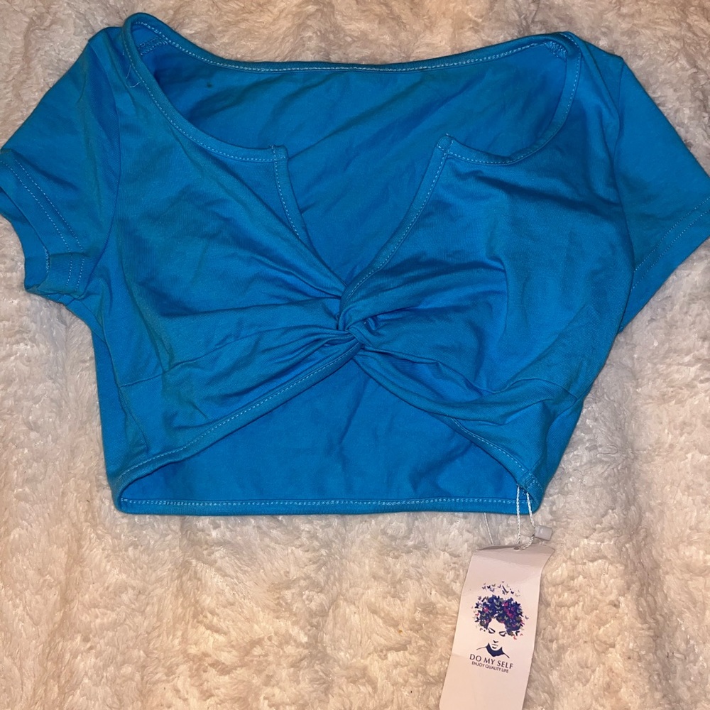 Blue cropped top with knotted detailing
in the front